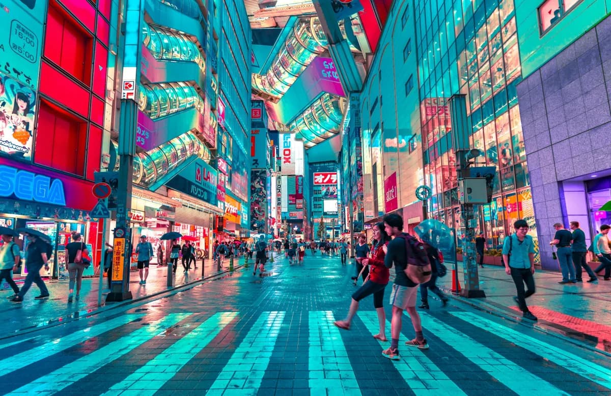 A busy retail district with illuminated storefronts and pedestrians.